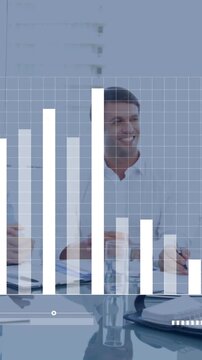 Animation of graph and loading bar over diverse coworkers discussing and shaking hands in office