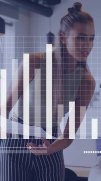 Business people working in office with bar graph animation over them