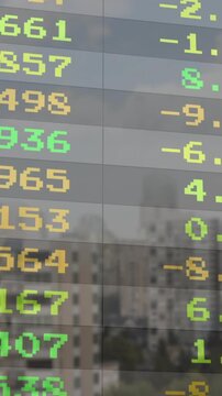 Animating stock market data over cityscape background, financial trends visualized