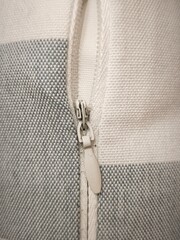 Macro Close Up of White Invisible Zipper Pull on Plaid Fabric Cushion Cover Textile Seam
