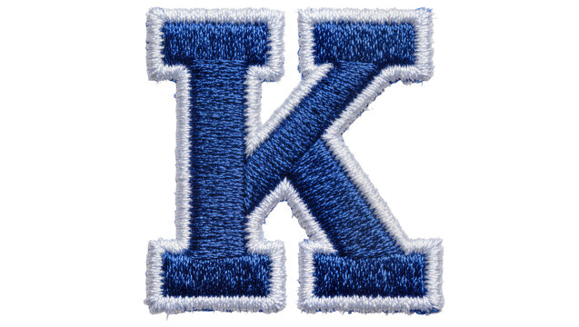 Blue embroidered letter K with white trim, isolated on transparent background