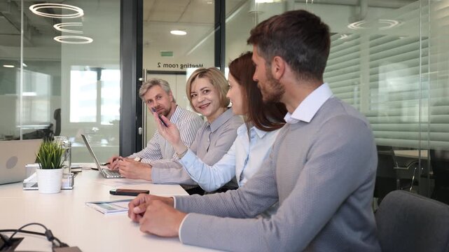 Business meeting - manager discussing work with his colleagues.
