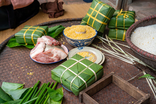 Traditional Vietnamese Banh Chung Wrapping with Glutinous Rice, Mung Bean, Pork, and Dong Leaves