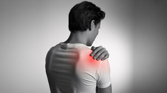 Shoulder pain and muscle tension, man holding painful joint with red glow, orthopedic injury and healthcare concept