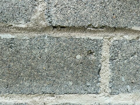 Rough concrete block wall texture with mortar joint close up photo