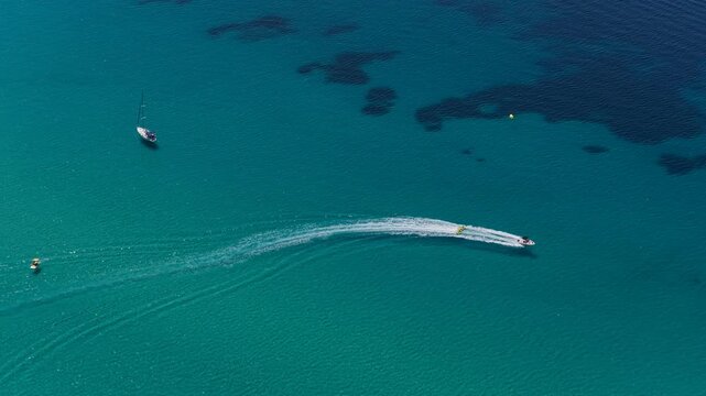 Speedboat carving a sweeping wake across turquoise Greek waters