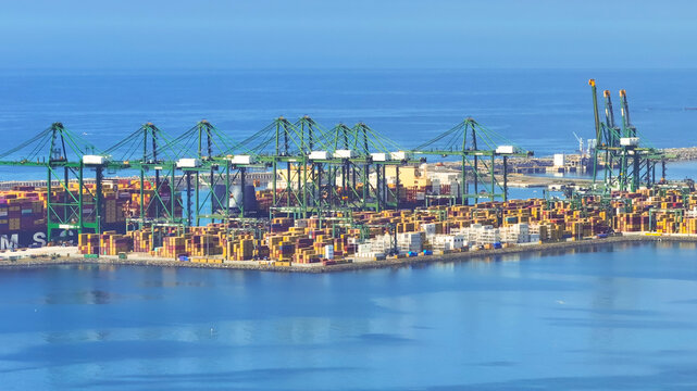 Sines, Portugal - 20 June 2026: Aerial view of the Sines container port featuring cargo ships, rows of colorful shipping containers, and large gantry cranes along the coastline.