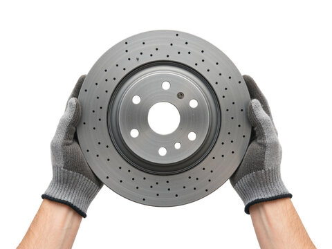 Two gloved hands holding a drilled brake disc, isolated on transparent background