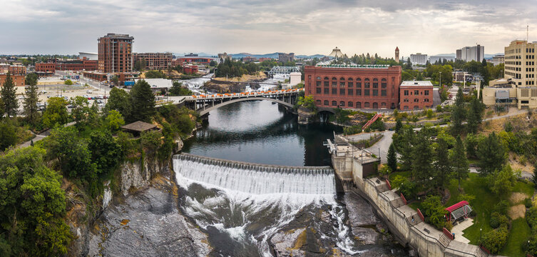 Spokane, Washington, United States - 15 August 2026: Aerial view of Spokane Falls on the Spokane River with the Post Street Bridge and downtown buildings.