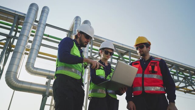 Industrial engineers inspecting an oil and gas refinery, reviewing plant operations and discussing maintenance, safety and energy infrastructure, refinery plant industry factory, Petrochemical plant.