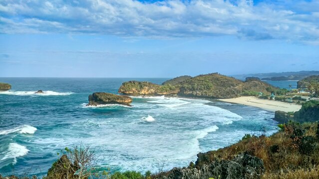 High Angle View of Pristine Srau Beach with Turquoise Waves and Karst Cliffs in Pacitan East Java Indonesia