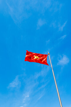 Vietnamese flag waving again the blue sky background in Vietnam
