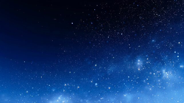 深い青の夜空に光の粒が広がる幻想的な背景