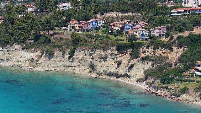 Skala Fourkas coastal cliffs and colorful hillside homes