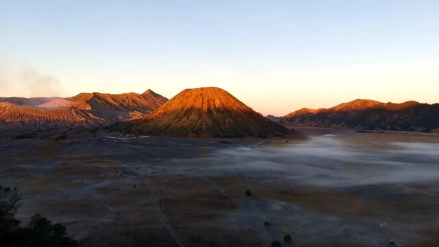 Aerial view of Mount Bromo with volcanic landscape and morning mist in Tosari, East Java, Indonesia.