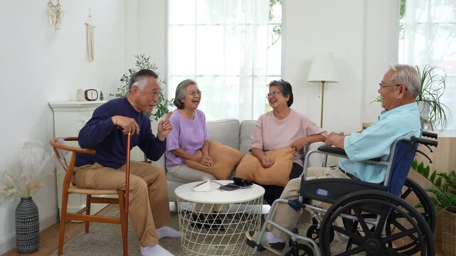 Four elderly friends enjoying a joyful conversation at home, with a wheelchair, walking cane, and blood pressure monitor, representing senior health, elderly care, wellness, and active aging.