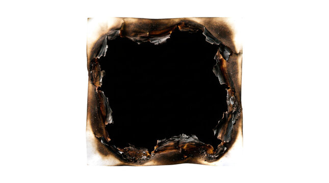 Burnt paper hole with charred edges and ash isolated on transparent background
