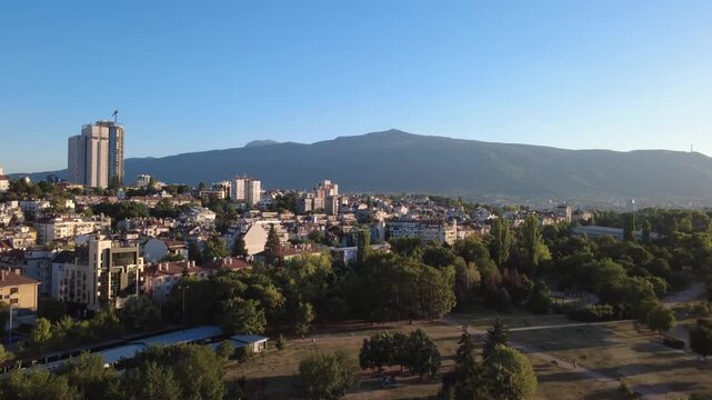 Aerial view of South Park with lush greenery, urban buildings, and Vitosha mountain in the background in Sofia, Sofia City Province, Bulgaria.
