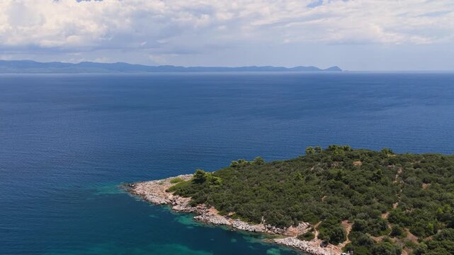 Rocky Greek peninsula extending into turquoise sea beneath