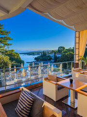 Obraz premium Luxury terrace lounge overlooking the sea coast and sun loungers in Dalmatia, Croatia.