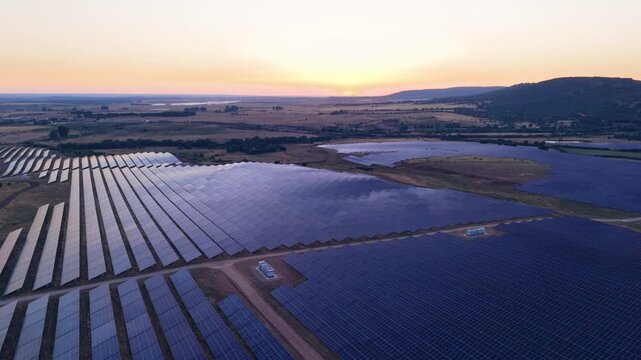 Aerial view of solar farm with rows of panels at sunset in Ciudad Rodrigo, Castile and Leon, Spain.