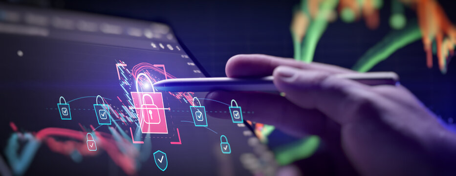 Financial cybersecurity concept. Hand using a stylus on a digital screen with trading charts and glowing padlock icons