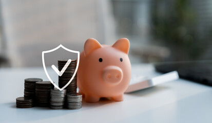 Piggy bank with stacked coins and security shield icon represents savings protection, financial...