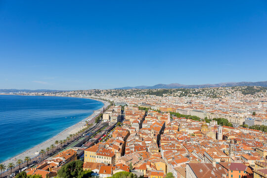 Aerial view of Nice, France with terracotta rooftops and Mediterranean Sea