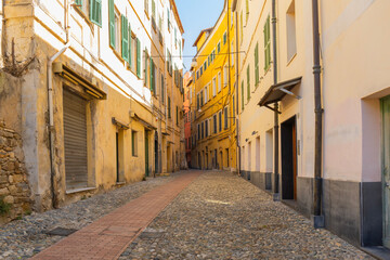Fototapeta premium Cozy narrow street with drying laundry in Liguria district, Sanremo, Italy