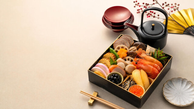 Japanese New Year osechi food in traditional boxes with copy space