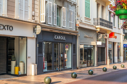 Cannes, France - August 02, 2026: Retail storefronts and fashion boutiques line a paved pedestrian shopping street