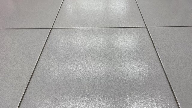 Grey ceramic floor tiles texture close up for background