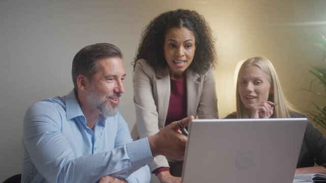 Concerned business team working on laptop as company project faces unexpected problems
