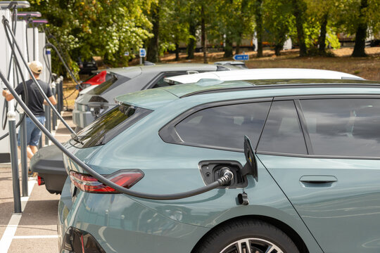 Electric car charging at a highway fast charging station, representing sustainable transportation, clean energy and the future of long-distance mobility
