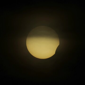 Eclipse of Sun, August 12, 2026. The sun is a gold dish in the sky gradually covered by the moon.