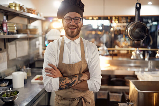 Cook in Professional Modern  kitchen, restaurant concept. Smiling chef portrait.