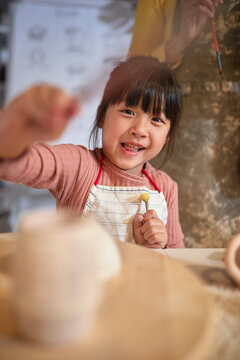 happy Creative chinese girl painting with brush at art class.  Creative, hobby ,activities concept
