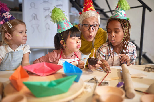 teacher and kid having fun and birthday party  on creative workshop.  Creative, hobby ,workshop  concept