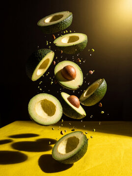Dynamic commercial levitation photography featuring fresh fruits slices and water droplets freezing mid-air over a bright yellow textured surface with dramatic studio side lighting.