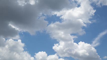 Fototapeta premium fluffy white clouds building up in the light blue sky