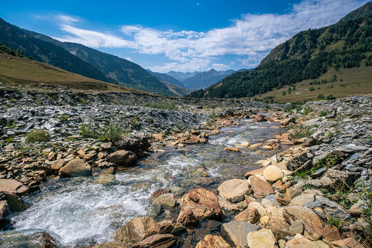 Senderismo por las monta&ntilde;as y valles del Valle de Aran en el Pririneo, caminando junto a un r&iacute;o alpino