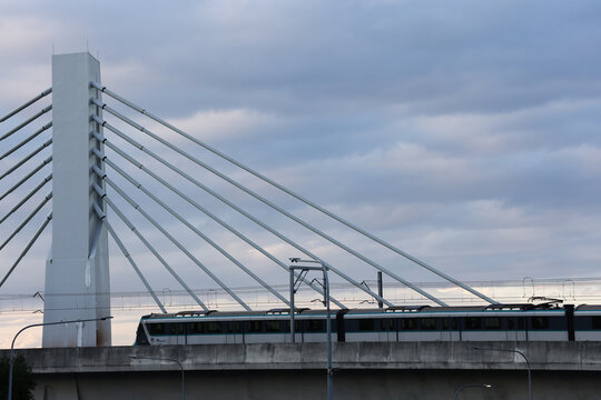 View of Sydney Metro train crossing cable stayed bridge at Rouse Hill