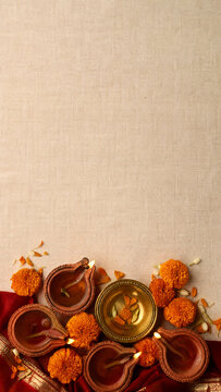 Diwali oil lamps and marigold flowers vertical banner with copy space