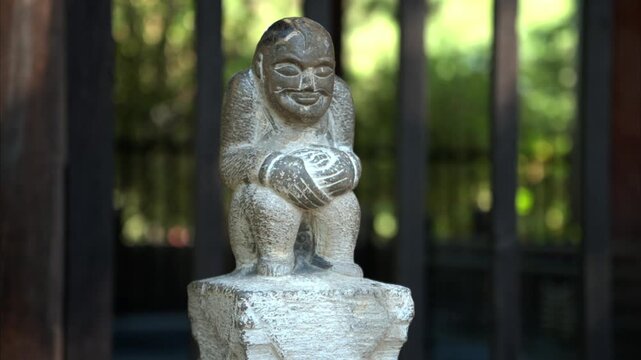 Stone Carved Monk Statue Squatting with Clasped Hands in Temple