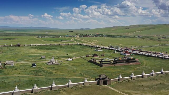 Aerial view of the historic Erdene Zuu Monastery surrounded by traditional white stupas and green grasslands in Kharkhorin, Ovorkhangai, Mongolia.