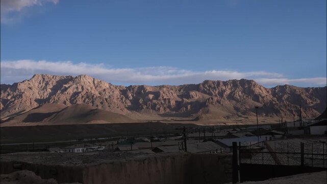 4K time-lapse of clouds rapidly moving over a mountain range near Murghab in the Pamir Mountains, Tajikistan