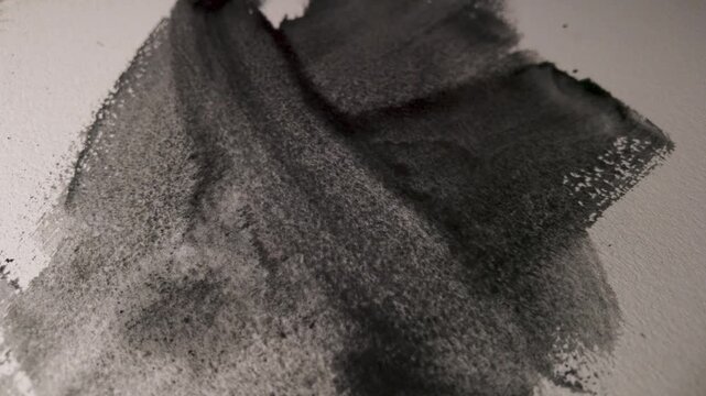 Layered watercolor graphite brushstrokes building an abstract composition, dark pigment spreading across textured paper in slow motion