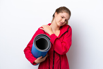 Teenager girl going to yoga classes while holding a mat isolated on white bakcground suffering from pain in shoulder for having made an effort © luismolinero