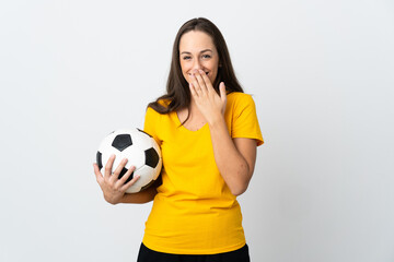 Young football player woman over isolated white background happy and smiling covering mouth with hand © luismolinero