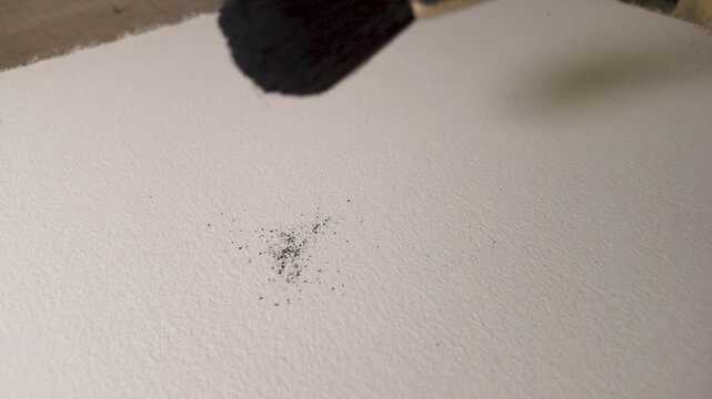 Watercolor graphite pigment spreading across textured paper, fluid organic patterns developing in slow motion